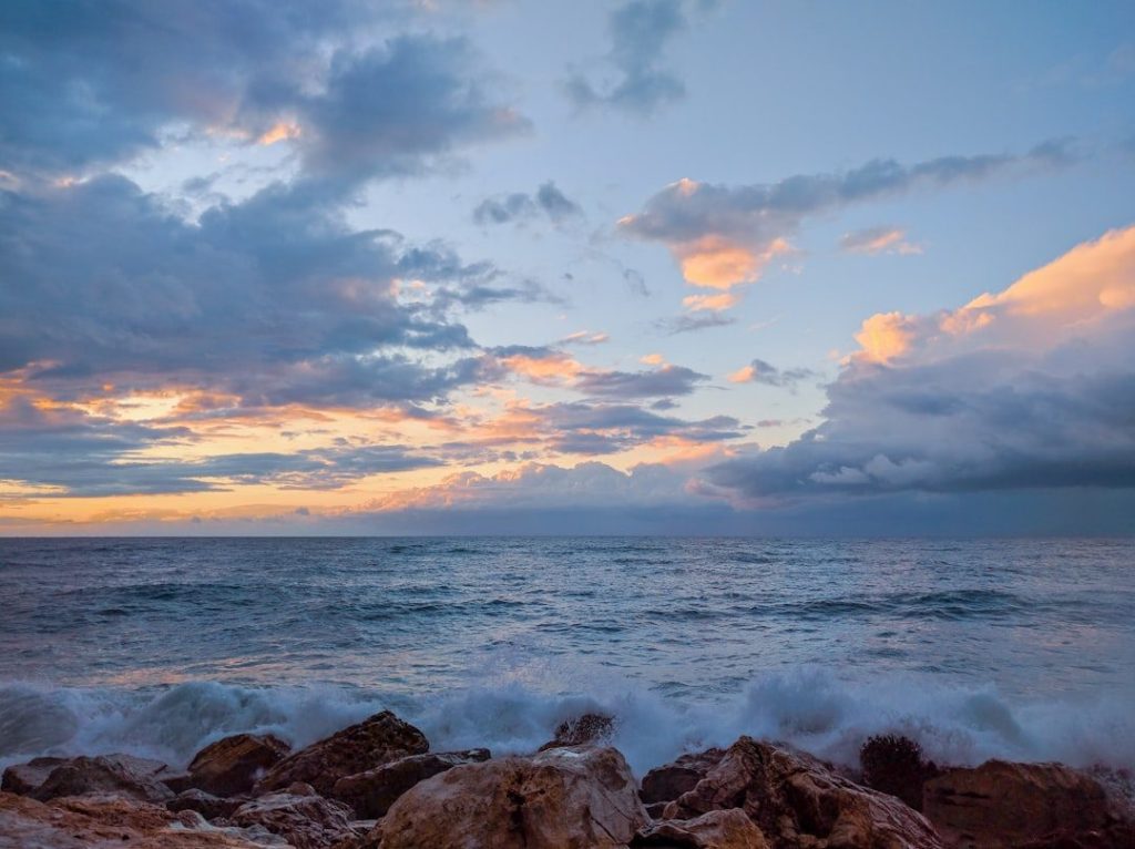 Ocean waves crashing on rocks during daytime